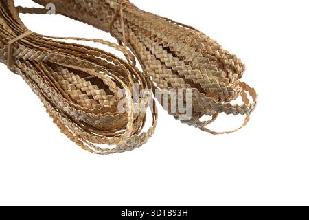 Natural straw.Straw weave close-up.Close-up of a pattern of braided textured straw ribbon woven from natural straw in isolation on a white background. Stock Photo