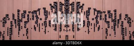 a modern, abstract wall art installation featuring a series of vertical, rectangular panels in varying shades of beige and gray. The scene evokes a se Stock Photo
