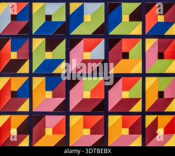 geometric mosaic artwork featuring a repeating pattern of interlocking triangles, arranged in a grid-like structure. The mosaic tiles creating a vibra Stock Photo