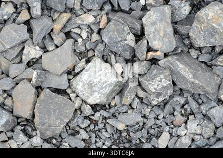 Pile of stone pebbles on the ground as background texture Stock Photo