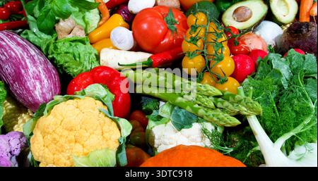 Fresh vegetables on display at a market showing a variety of colors and shapes during a sunny afternoon Stock Photo