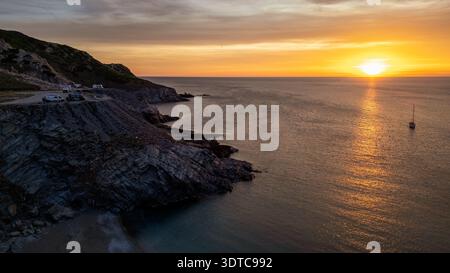 A stunning aerial view capturing the essence of freedom and road tripping at Capo dell'Argentiera, Sardinia. The photograph shows several camper vans Stock Photo