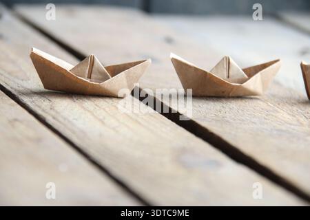 Paper boats on a vintage background. Stock Photo