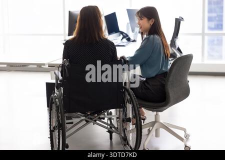 Back view of business professional woman with disability using wheelchair Stock Photo