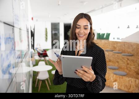 Cheerful Asian project manager man analyzing Internet marketing report Stock Photo