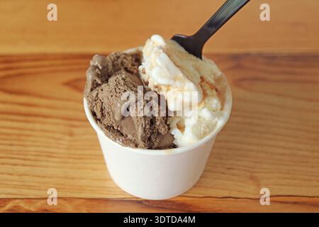 Spoon Scooping into Mouthwatering Caramel and Chocolate Ice Cream Stock Photo