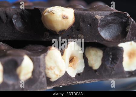 Chocolate bar with nuts on a dark background Stock Photo