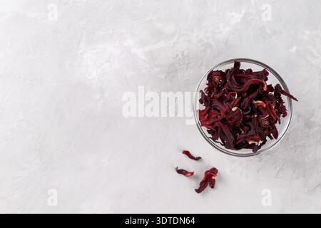 Red hibiscus dried flowers for healthy tea on grey stone background, top view copy space Stock Photo