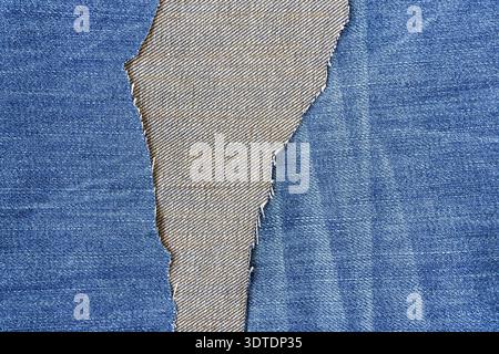 Denim blue jeans fabric. Ripped denim fabric. Destroyed torn denim blue jeans texture Stock Photo