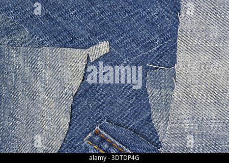 Blue jeans destroyed and torn with a seamless patchwork pattern. Denim fabric for background and fashion wallpaper. Grunge or hippie style Stock Photo