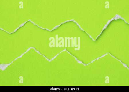 Hole ripped in a green paper. Copy space Stock Photo