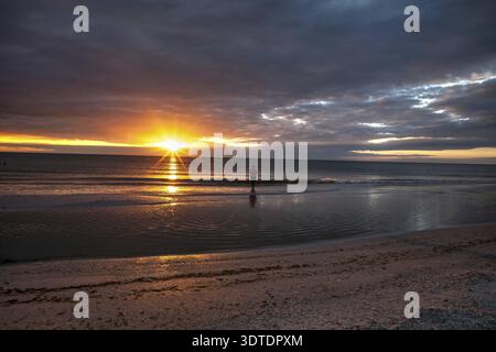 Man fishes along Tigertail Beach at sunset on Marco Island, Florida Stock Photo