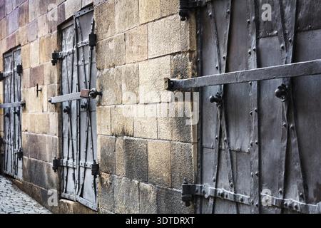 Old windows closed with iron shutters Stock Photo