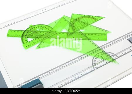 Drawing board with measuring instruments on a white background Stock Photo