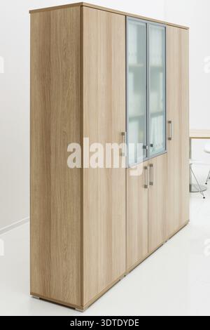 Wooden bookcase on the background of white walls Stock Photo