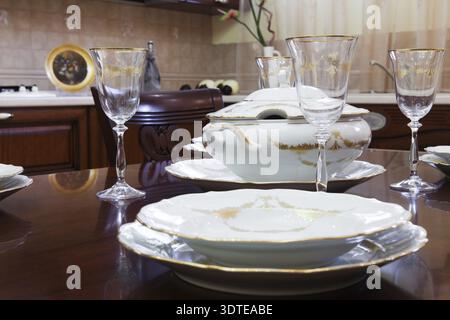 Glasses and plates on a wooden table Stock Photo