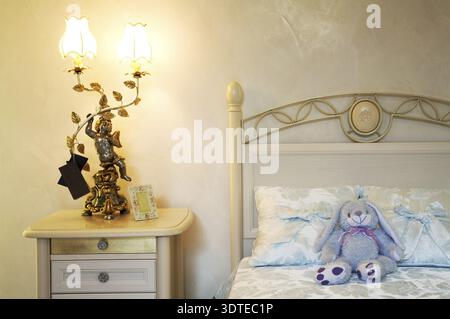 Toy hare on a bed in a childrens bedroom Stock Photo