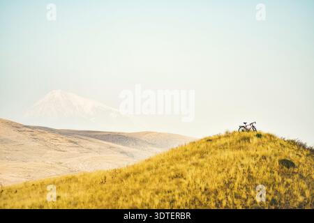 Touring bicycle uphill stand on mountain viewpoint. Off-road cycling outdoors in mountains extreme challenging conditions. Love bicycle and addiction Stock Photo