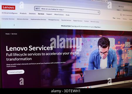Computer screen displaying a website with a man working on a laptop, showing digital services and technology transformation solution. Stock Photo
