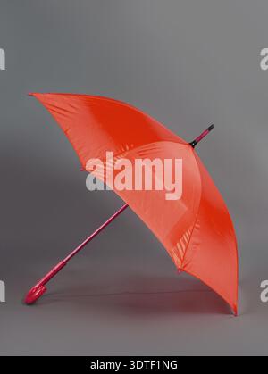 Opened red umbrella isolated on gray background Stock Photo