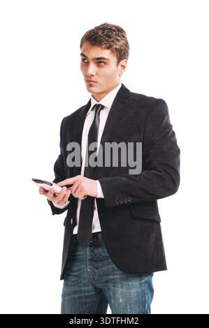 Portrait of handsome young business man using cell phone, smiling Stock Photo
