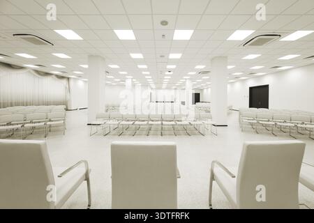 Large and modern white auditorium with curtains Stock Photo