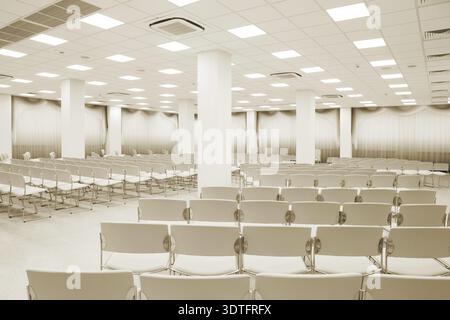 Large and modern white auditorium with curtains Stock Photo