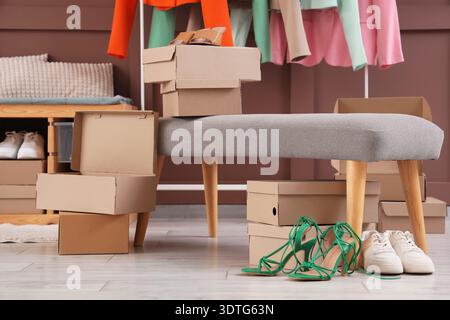Soft bench with shoe boxes in dressing room Stock Photo