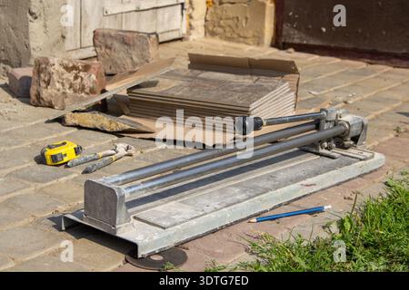 for cutting ceramic tile work tool tile cutter in the workplace in the yard lies Stock Photo