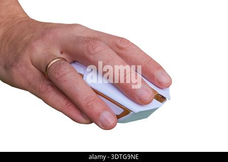 working on a wireless computer mouse on a white background, hand clicks on the mouse Stock Photo
