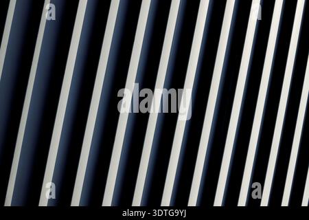 A close-up view of parallel diagonal lines in alternating dark blue and white shades, forming a striking abstract background with a sense of depth and Stock Photo