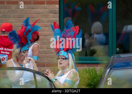 Dancers from the Suffolk School of Samba at the annual Framlingham Gala parade through the Suffolk market town assemble in a car park beforehand. Stock Photo