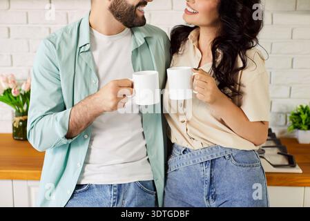 Happy couple in love drinking coffee, enjoying breakfast together at home Stock Photo