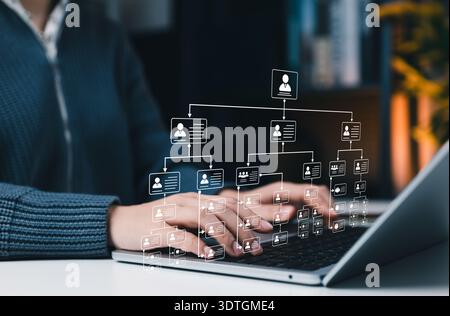 Organizational structure concept. professional using laptop with hierarchy chart representing corporate management system, team structure, workflow Stock Photo