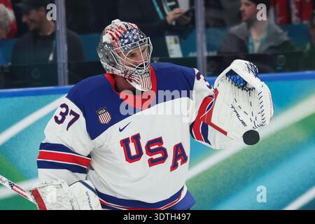 United States' Connor Hellebuyck (37) makes a save on a shot by Canada