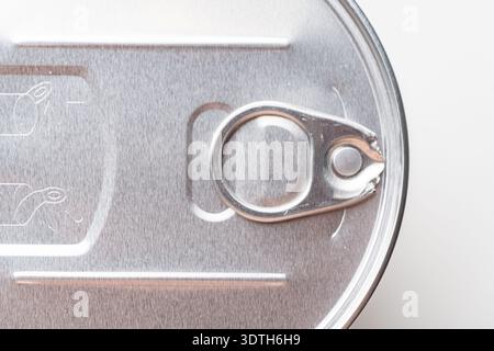 Close-up of a closed metal jar lid with an opening ring, on a white background, perfect for food packaging concepts. High quality photo Stock Photo