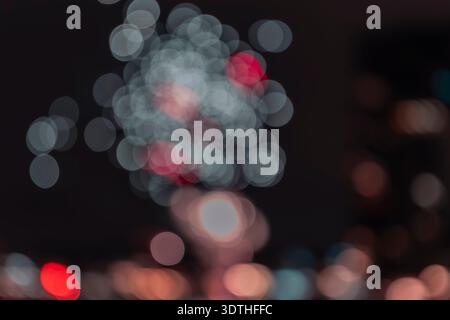 Festive New Year Fireworks Bokeh Lights on Dark Night Background. A mesmerizing abstract background featuring the out-of-focus glow of New Year's Eve Stock Photo