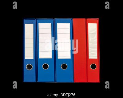 Neatly arranged blue and red lever arch binders standing side by side on a white background, ideal for office organization, document storage, filing a Stock Photo