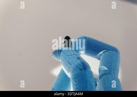 Close-up of a robotic hand interacting with pharmaceutical pills, symbolizing artificial intelligence in healthcare, digital medicine, automation in p Stock Photo