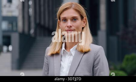 Headshot successful Caucasian adult business woman smiling at camera looking happy businesswoman female leader professional manager cheerful glad Stock Photo