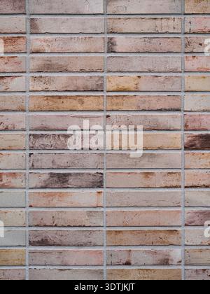 Detailed texture of modern narrow brick wall cladding in earthy tones Stock Photo