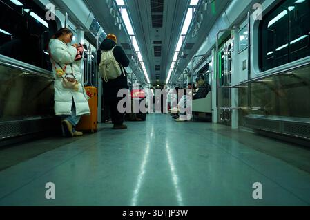 Passengers standing on a moving train  (Line 5 subway) of Seoul, South Korea Stock Photo