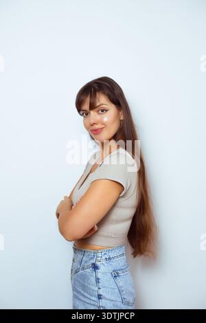 Side view portrait of confident young woman isolated on neutral background. Stock Photo