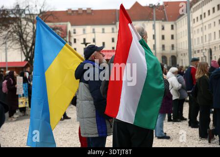 Two man holding a Ukrainian and Hungarian flag during a remembrance event of the 4th anniversary of the war in Ukraine in Budapest, Hungary Stock Photo