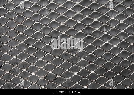 Metal mesh on a gray background. Close-up, top view. Background. High quality photo Stock Photo