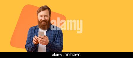 Man Using Smartphone While Standing Against a Bright Yellow Background During Daytime Stock Photo
