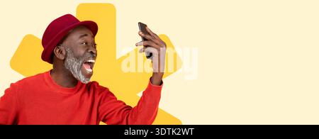Smiling Man Holds Phone While Enjoying a Moment in a Bright and Cheerful Setting Stock Photo