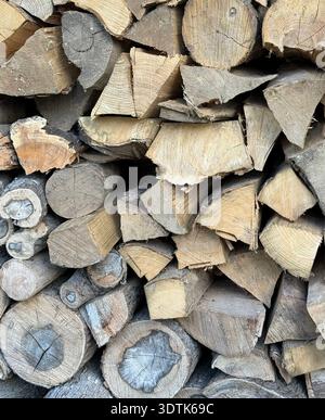 Close-up of stacked cut logs showing detailed wood grain and bark texture. Natural background suitable for rural, forestry and sustainable energy. Stock Photo