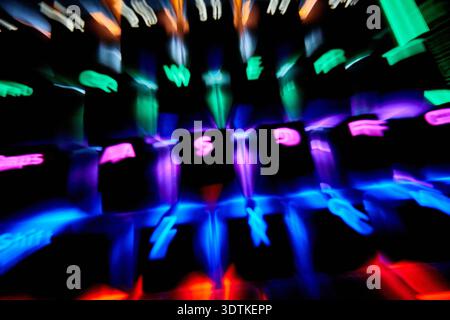 An abstract photograph of a computer keyboard with RGB backlighting, characterized by vibrant light trails and a strong motion blur effect. The illumi Stock Photo