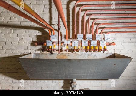 Heating/pipe distribution system with bilingual labels in Belgian broadcast station VRT/RTBF-TV station, Wavre, Belgium Stock Photo